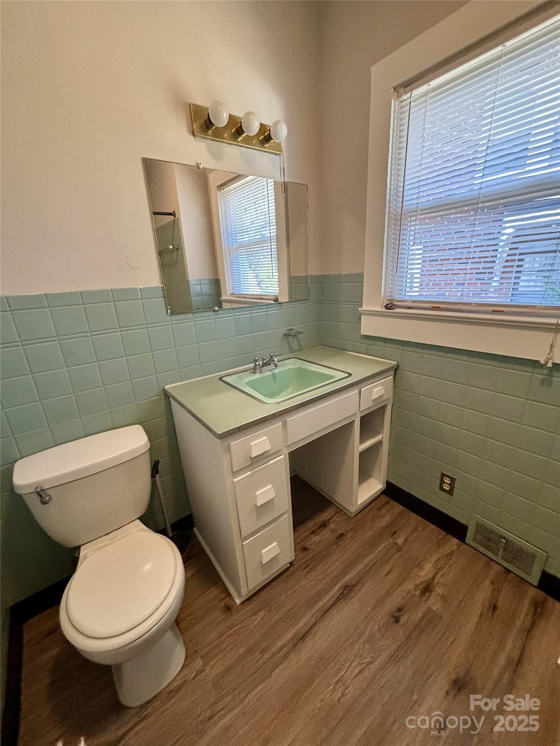 455 Spring Street Albemarle, NC 28001 - Photo 23 of 32 a bathroom with a toilet sink and mirror