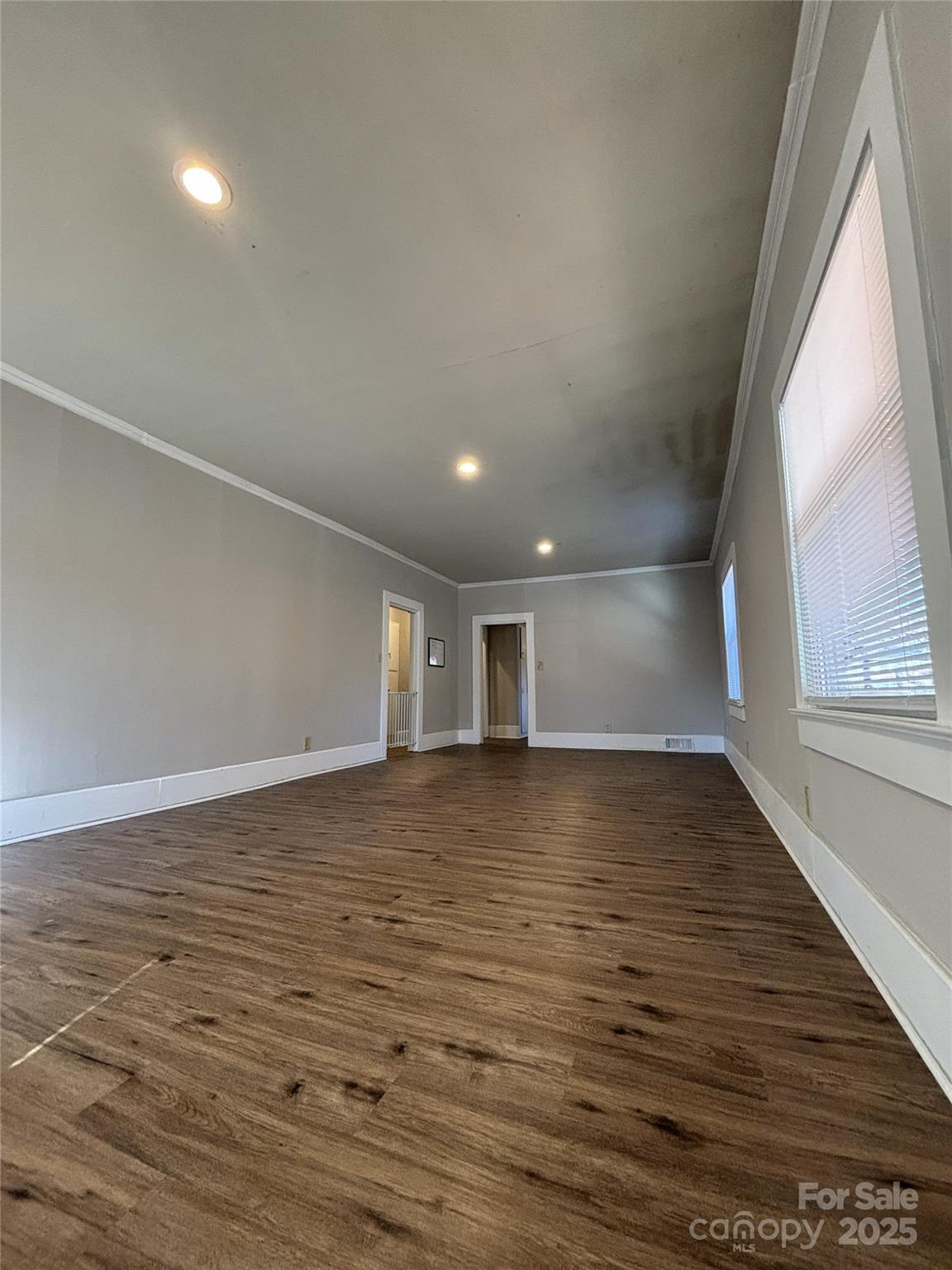 455 Spring Street Albemarle, NC 28001 - Photo 4 of 32 a view of a room with wooden floor and window