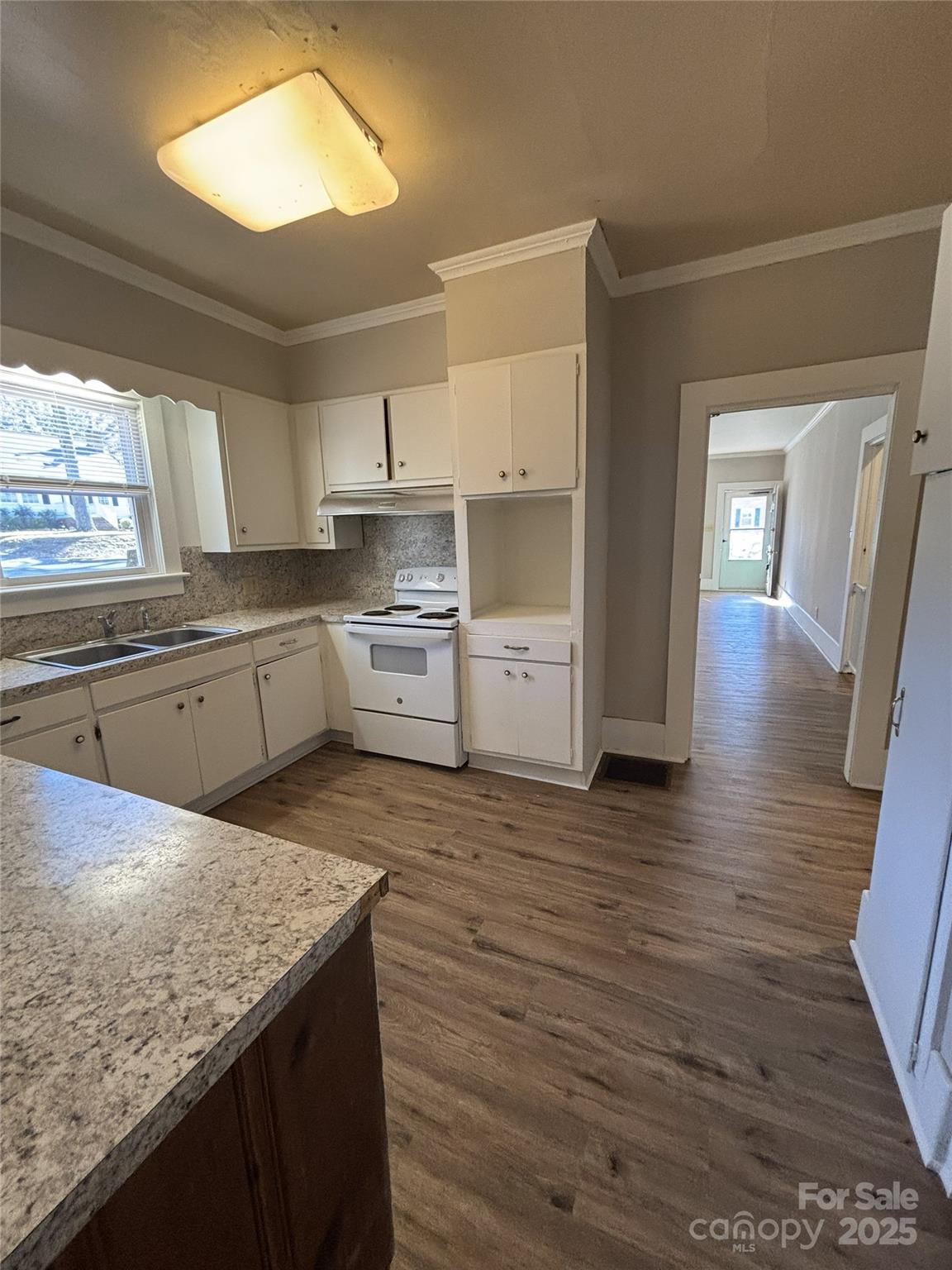 455 Spring Street Albemarle, NC 28001 - Photo 6 of 32 a kitchen with granite countertop a stove a sink and a refrigerator