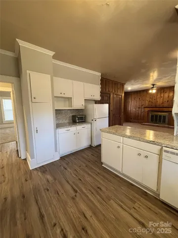 a kitchen with white cabinets and white appliances