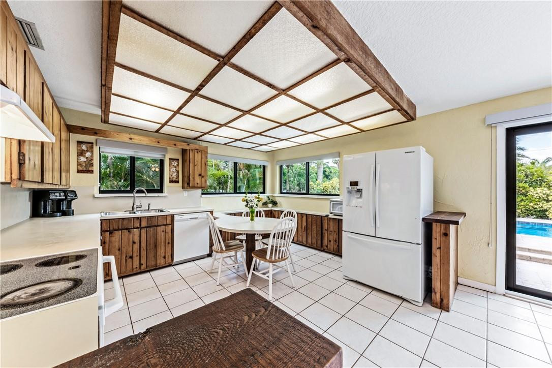 11301 Southwest 16th Street Davie, FL 33325 - Photo 16 of 54 a kitchen view with a dining table chairs and refrigerator
