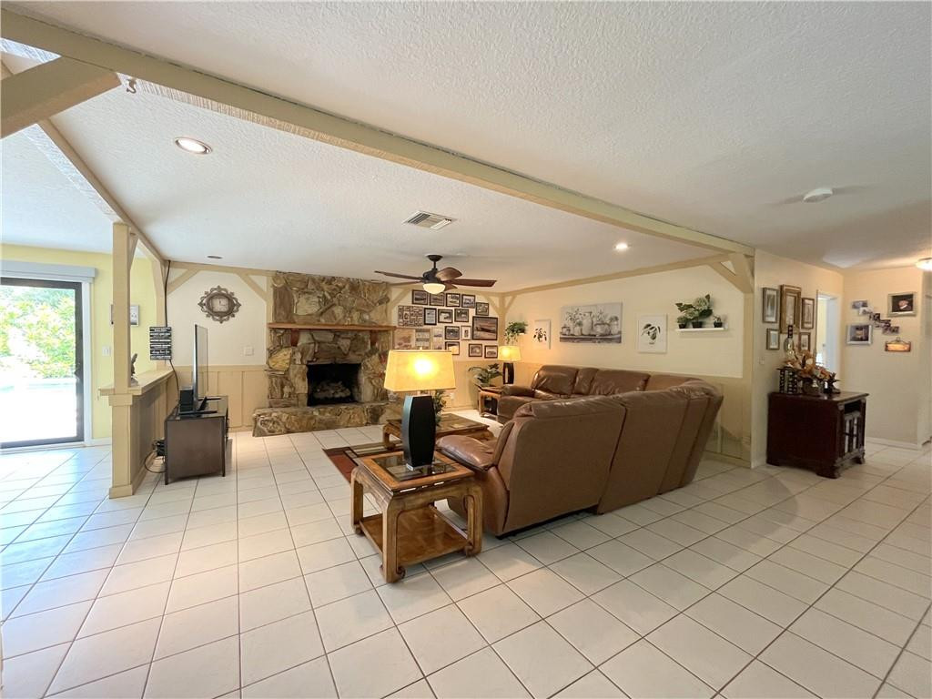11301 Southwest 16th Street Davie, FL 33325 - Photo 20 of 54 a living room with furniture and a chandelier