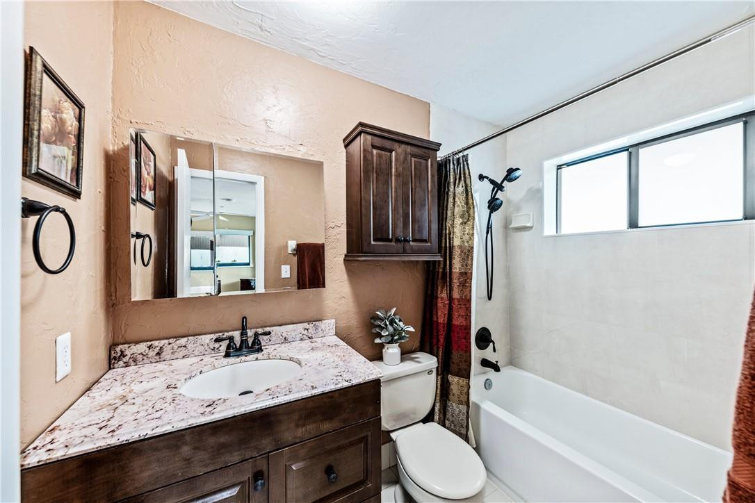 11301 Southwest 16th Street Davie, FL 33325 - Photo 27 of 54 a bathroom with a granite countertop sink toilet and shower