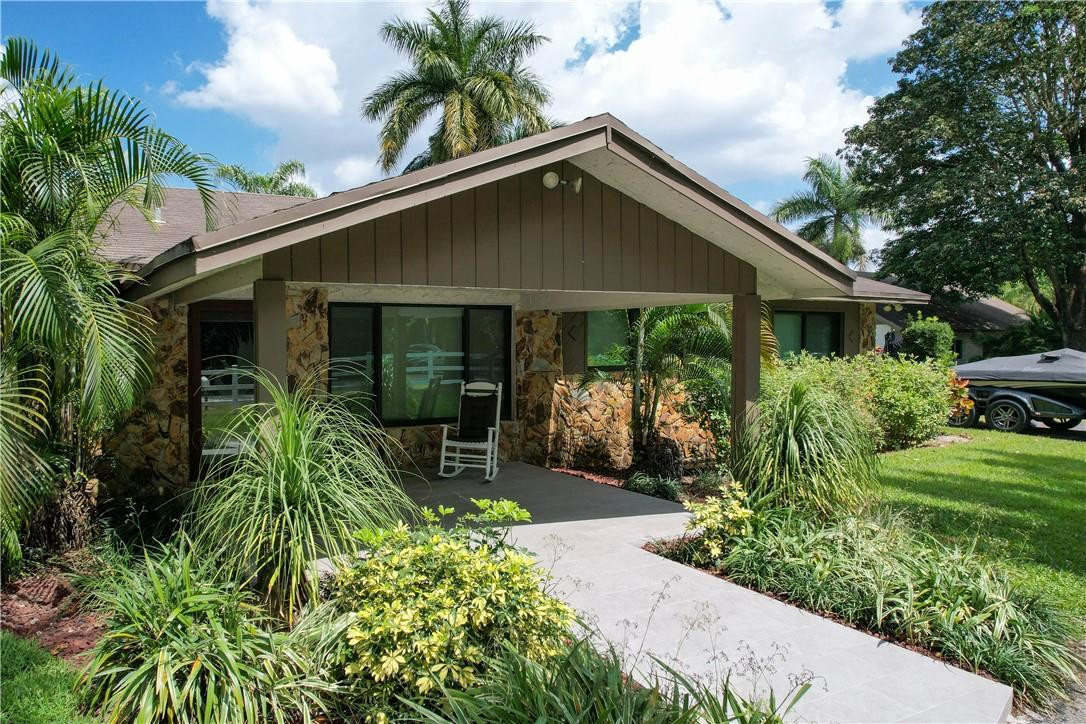 11301 Southwest 16th Street Davie, FL 33325 - Photo 30 of 54 a front view of house with yard and outdoor seating