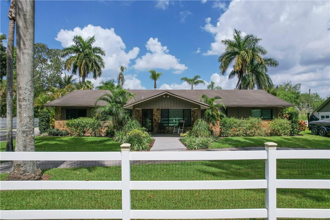 11301 Southwest 16th Street Davie, FL 33325 - Photo 35 of 54 a front view of a house with a yard and fountain