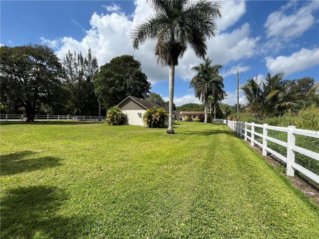 11301 Southwest 16th Street Davie, FL 33325 - Photo 50 of 54 a view of a swimming pool with a yard and palm trees