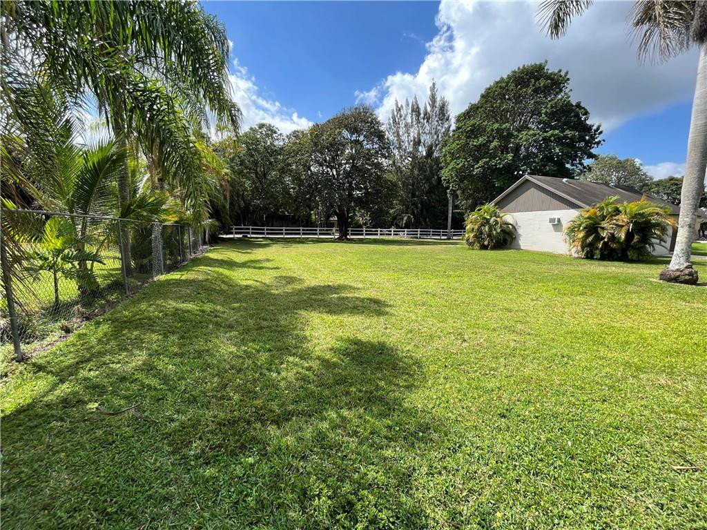 11301 Southwest 16th Street Davie, FL 33325 - Photo 51 of 54 a view of a big yard with potted plants and large trees