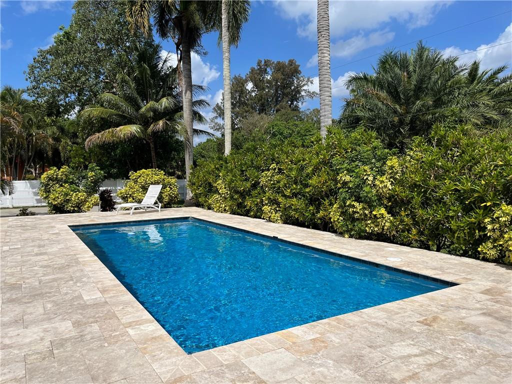 11301 Southwest 16th Street Davie, FL 33325 - Photo 8 of 54 a view of a swimming pool with a chair and tables