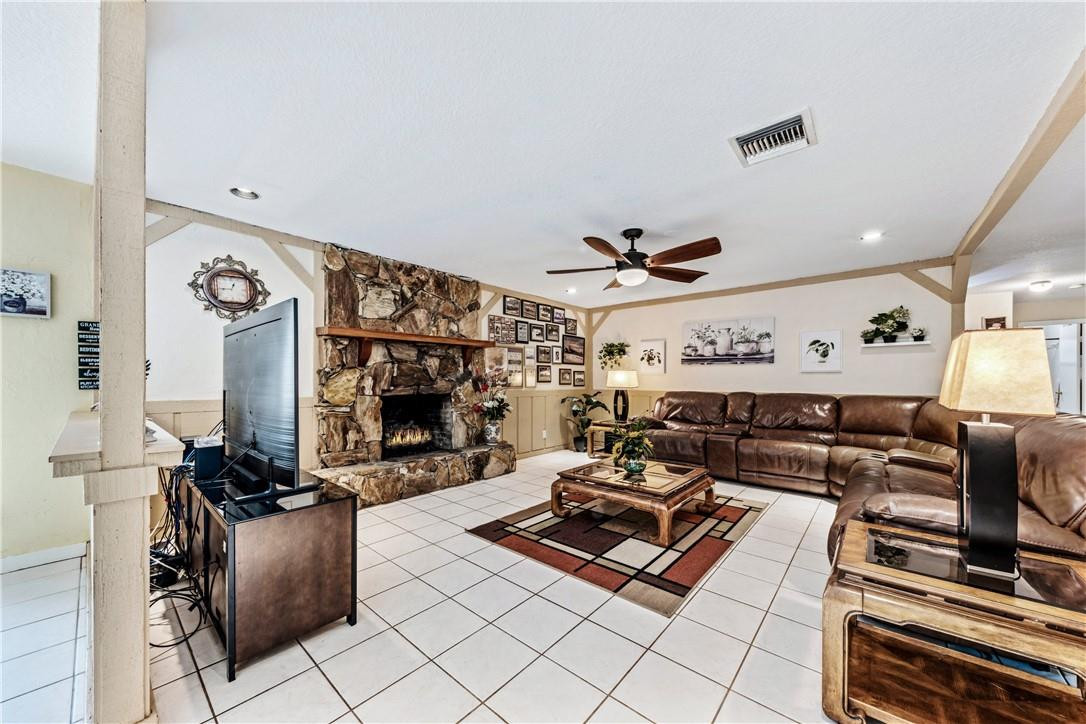 11301 Southwest 16th Street Davie, FL 33325 - Photo 10 of 54 a living room with furniture a flat screen tv and a fireplace