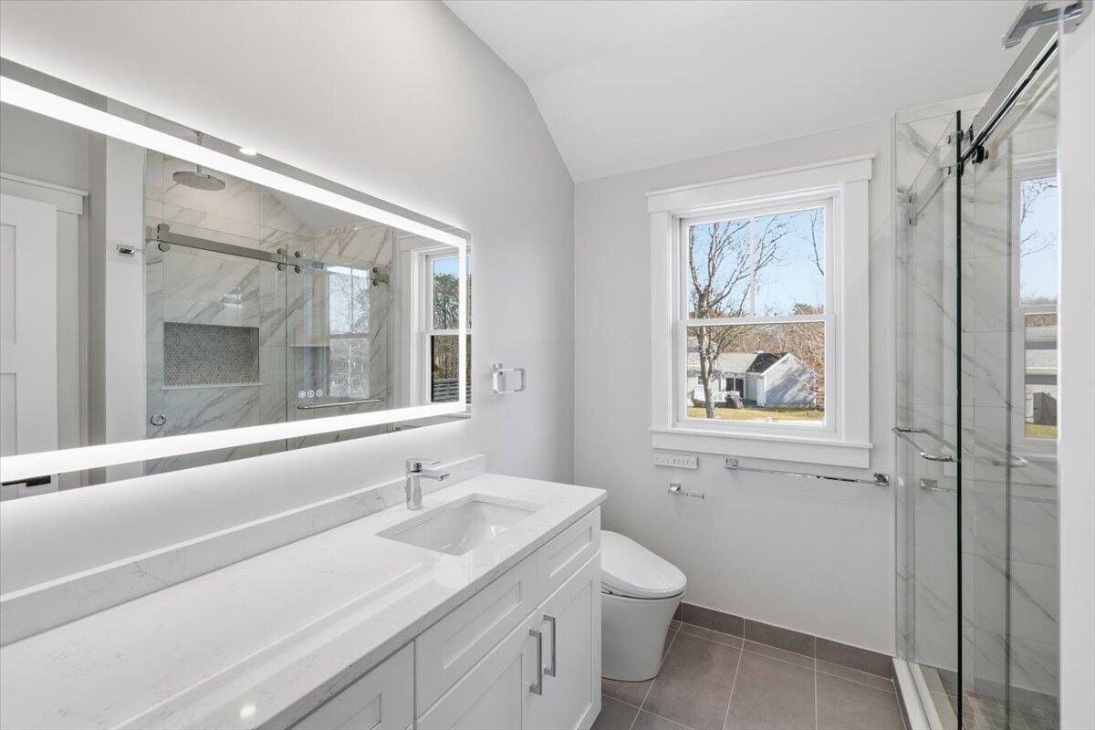 58 Old Chatham Road Brewster, MA 02631 - Photo 30 of 43 a bathroom with a granite countertop sink toilet and painting on the wall