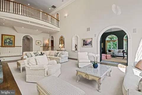 a living room with furniture fireplace and a large window