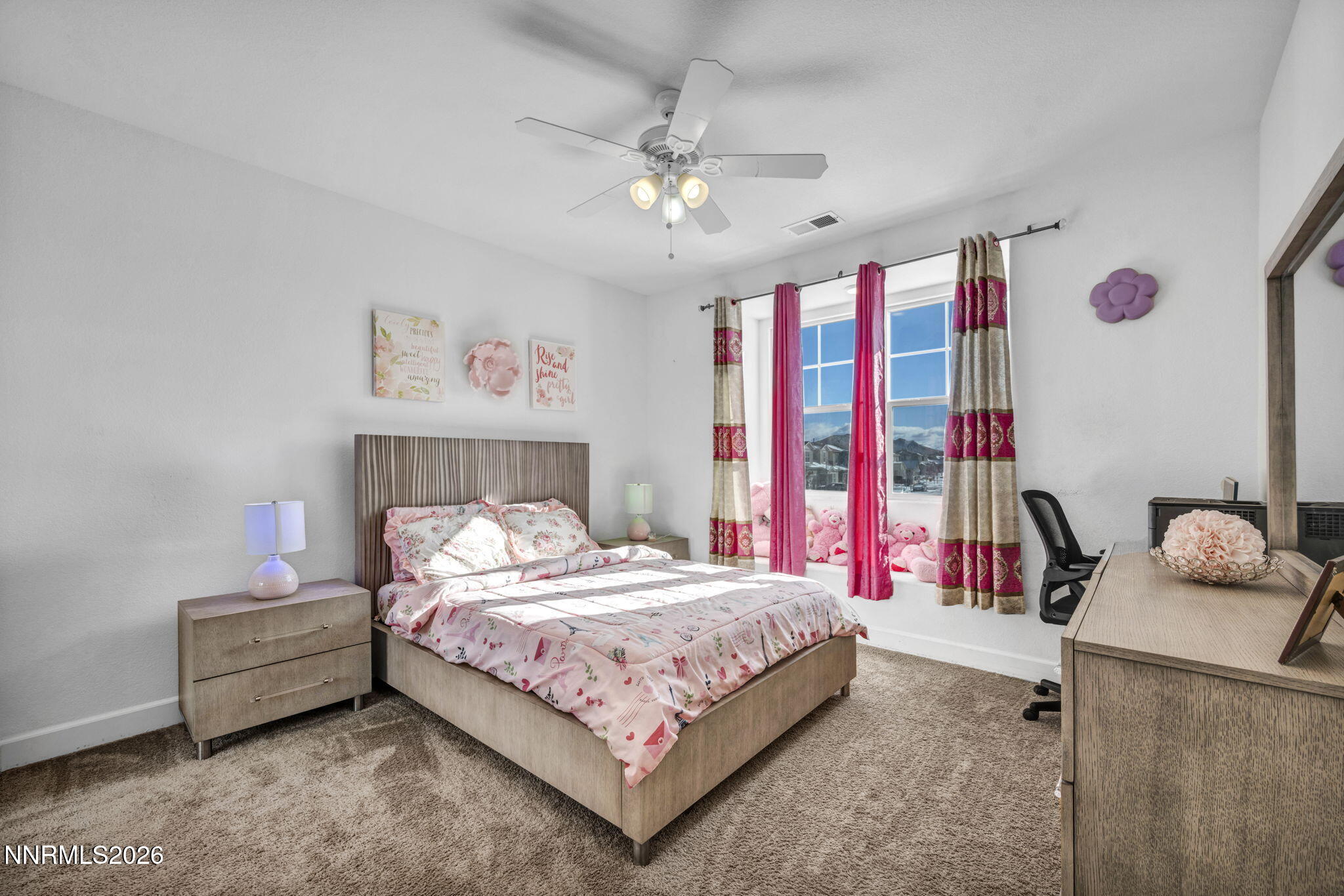 969 Estuary Circle Reno, NV 89506 - Photo 21 of 38 a bedroom with a bed and a chandelier