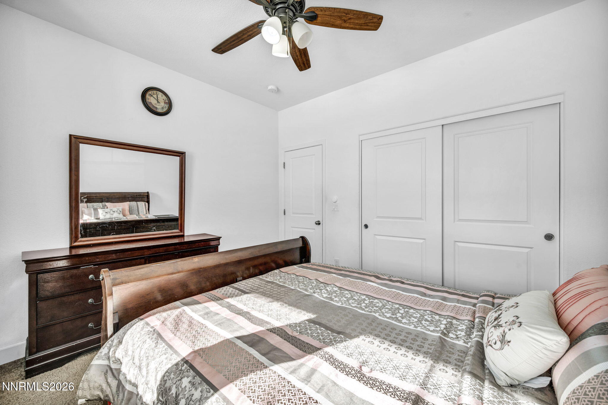 969 Estuary Circle Reno, NV 89506 - Photo 24 of 38 a bedroom with a bed and a chandelier