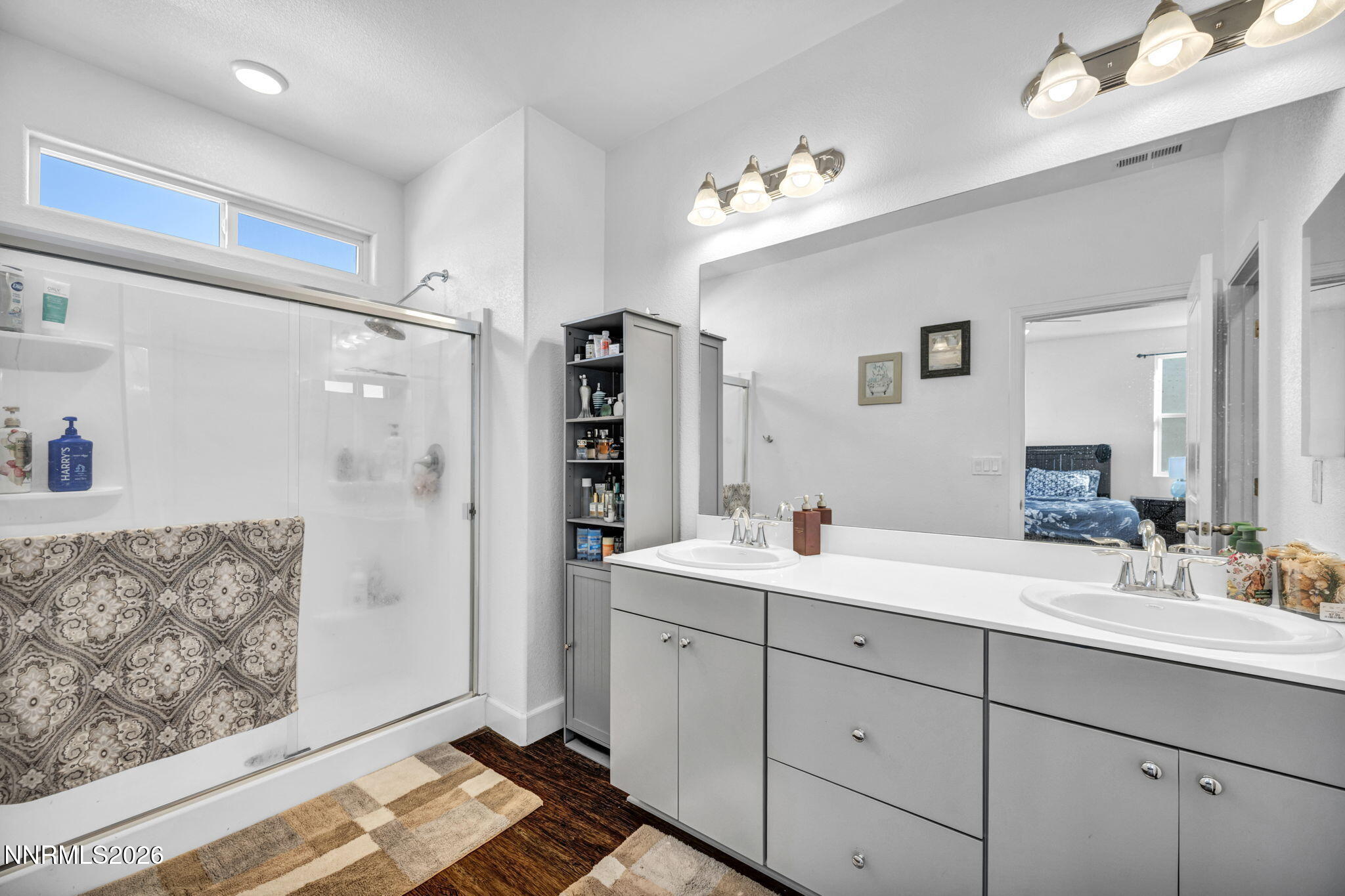 969 Estuary Circle Reno, NV 89506 - Photo 26 of 38 a en suite bathroom with double sink a mirror and a shower