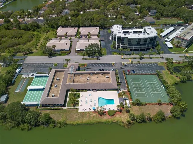 an aerial view of residential houses with outdoor space and parking