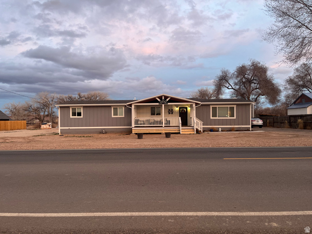 558 North N Cres Road Roosevelt, UT 84066 - Photo 2 of 31 Single-story residence featuring gray siding, white trim, and a covered front porch with white railings