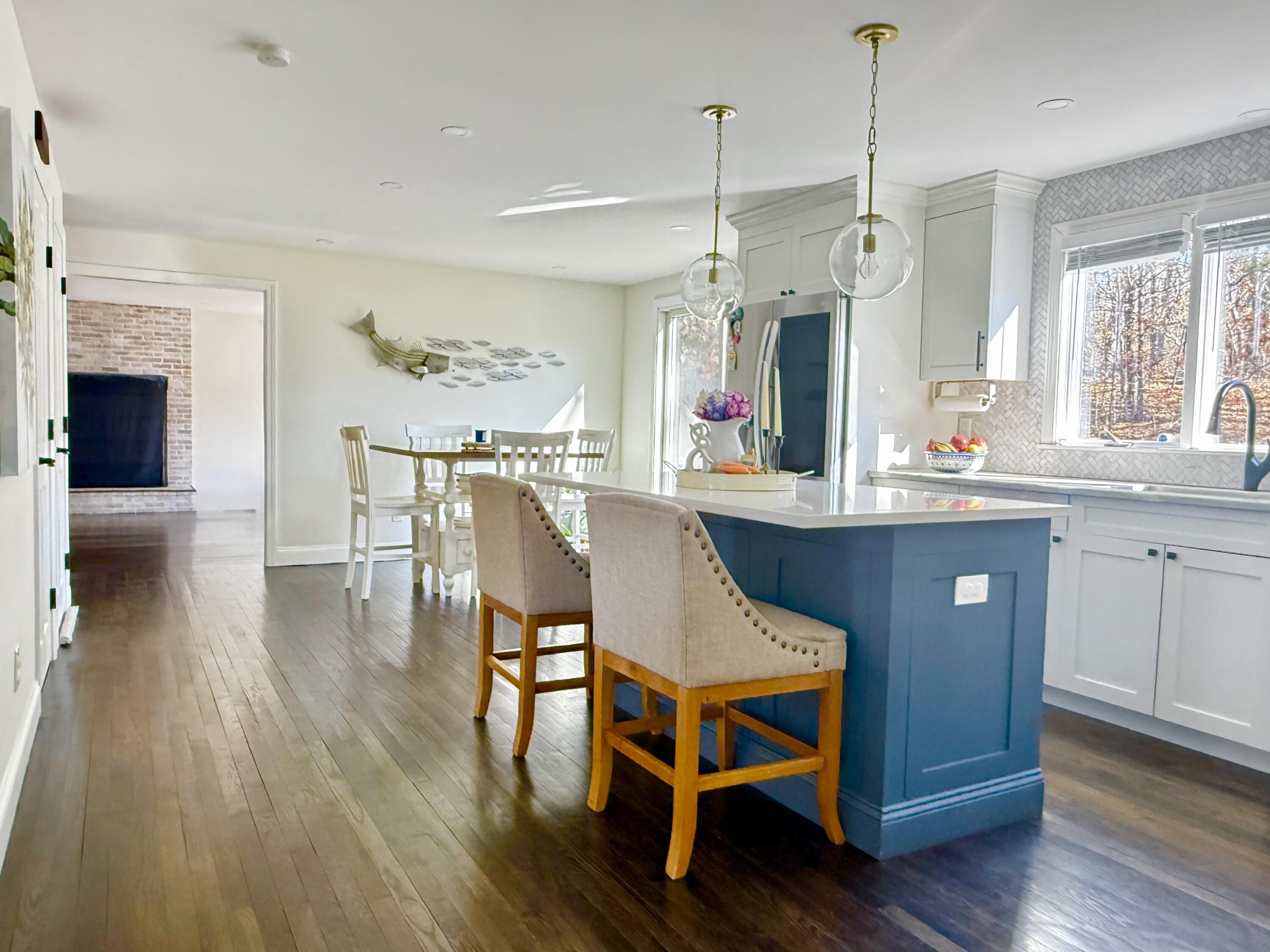 117 A P Newcomb Road Brewster, MA 02631 - Photo 11 of 69 a kitchen with stainless steel appliances granite countertop a kitchen island a stove a table and chairs in it