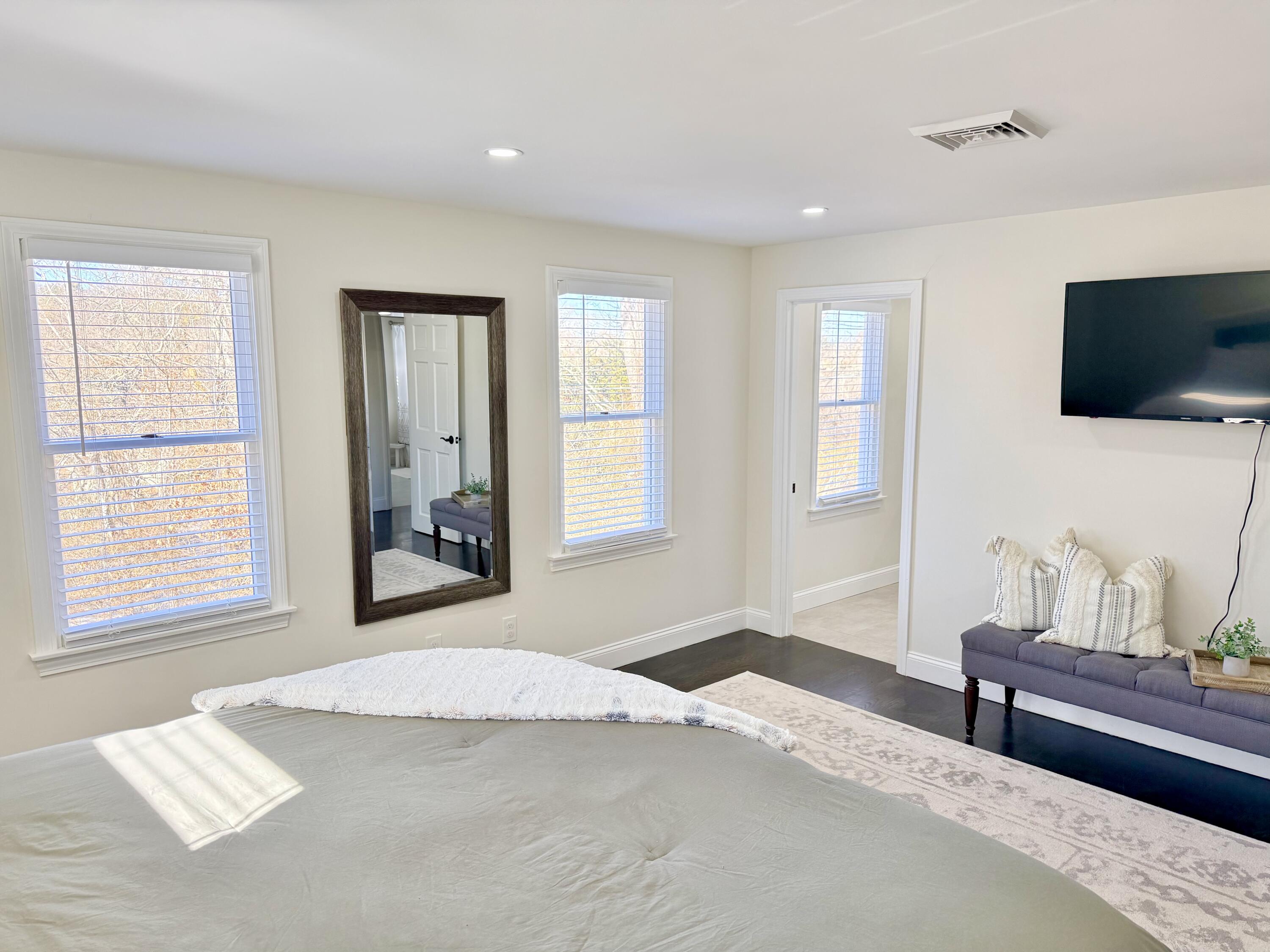 117 A P Newcomb Road Brewster, MA 02631 - Photo 28 of 69 a bedroom with a bed and a flat screen tv