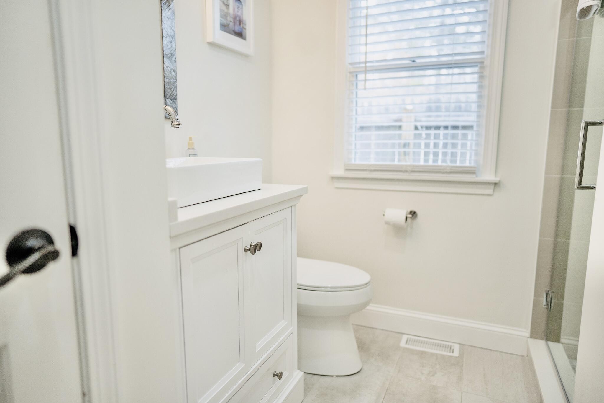117 A P Newcomb Road Brewster, MA 02631 - Photo 44 of 69 a bathroom with a sink a toilet and a window