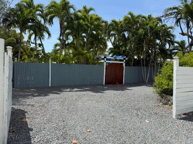 a view of a house with backyard sitting area and garden