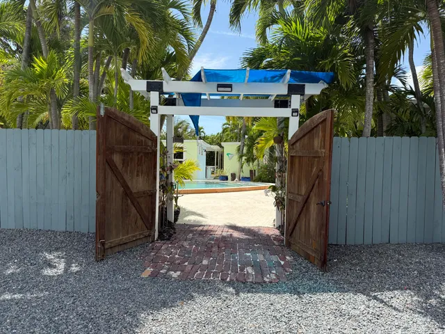 a view of a house with backyard sitting area and garden