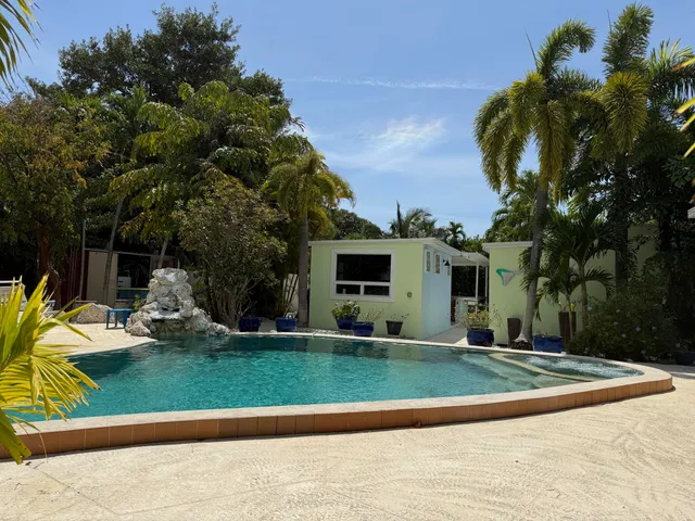 a view of a house with backyard porch and sitting area
