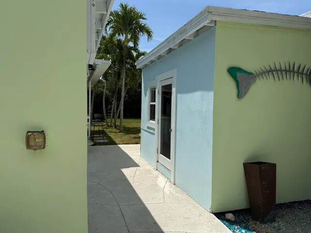 a dining room with furniture and large windows