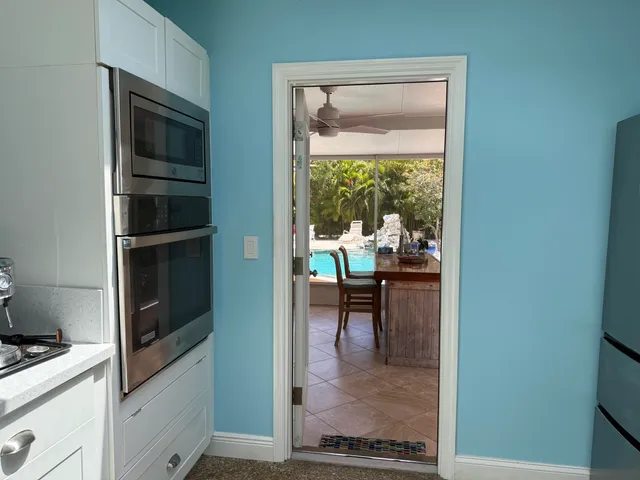 a living room with furniture and a book shelf
