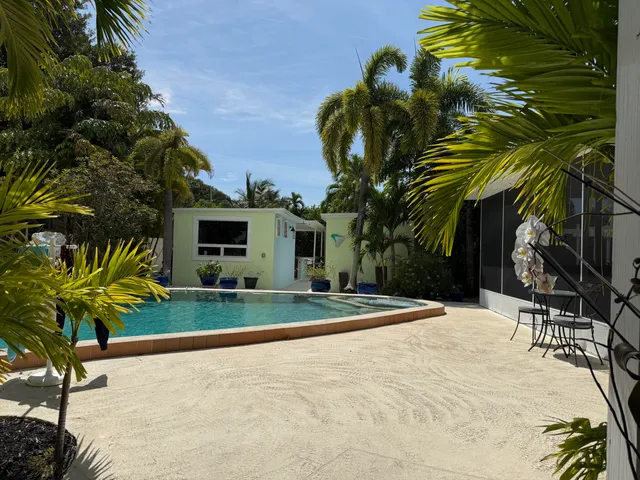 a view of a patio with table and chairs and potted plants