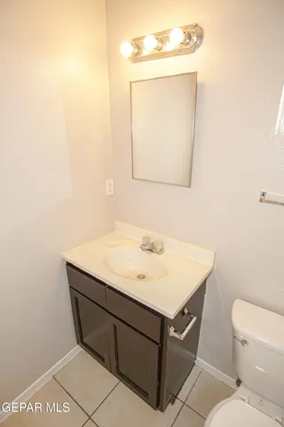 a bathroom with a sink toilet and mirror
