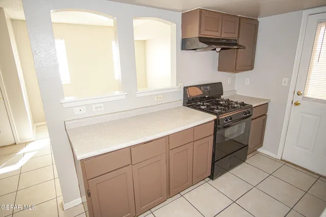 a kitchen with a stove and a sink