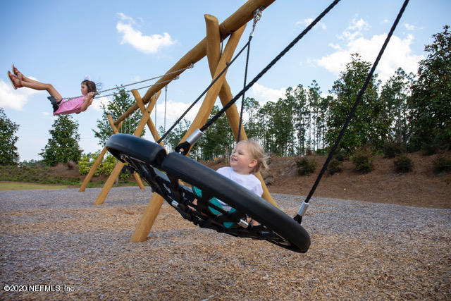 594 Buttonwood Loop Yulee, FL 32097 - Photo 31 of 39 Kids on Swings at Waterbug Park