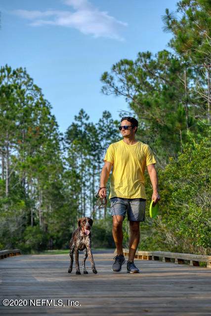 594 Buttonwood Loop Yulee, FL 32097 - Photo 35 of 39 Walking Dog on Trail