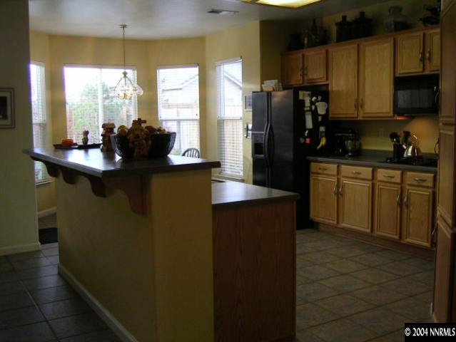 9965 Rio Bravo Drive Reno, NV 89521 - Photo 3 of 6 a kitchen with stainless steel appliances a sink stove and refrigerator
