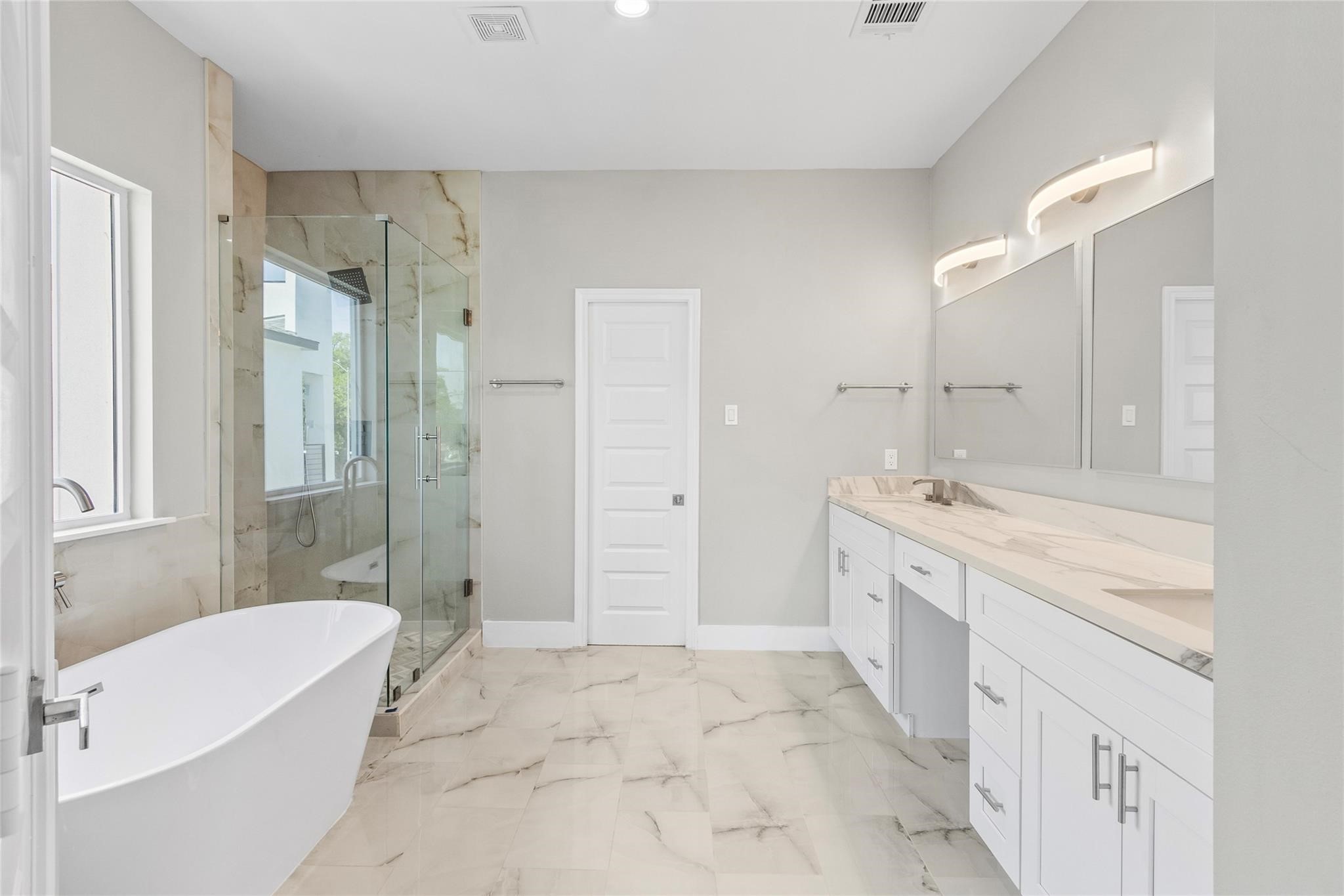 5506 Pershing Street Houston, TX 77033 - Photo 12 of 29 a bathroom with a granite countertop sink a toilet a mirror a bathtub and shower