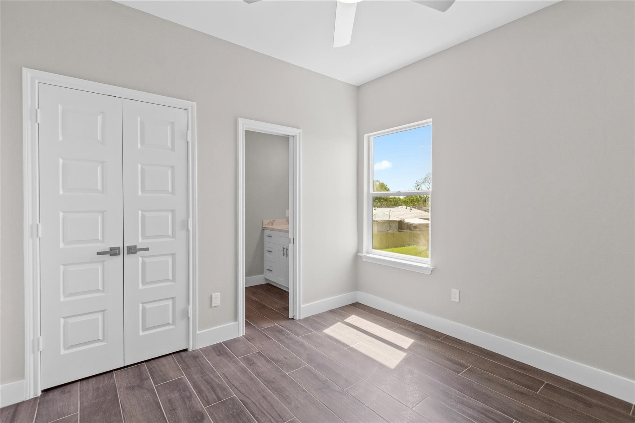 5506 Pershing Street Houston, TX 77033 - Photo 17 of 29 an empty room with wooden floor and windows