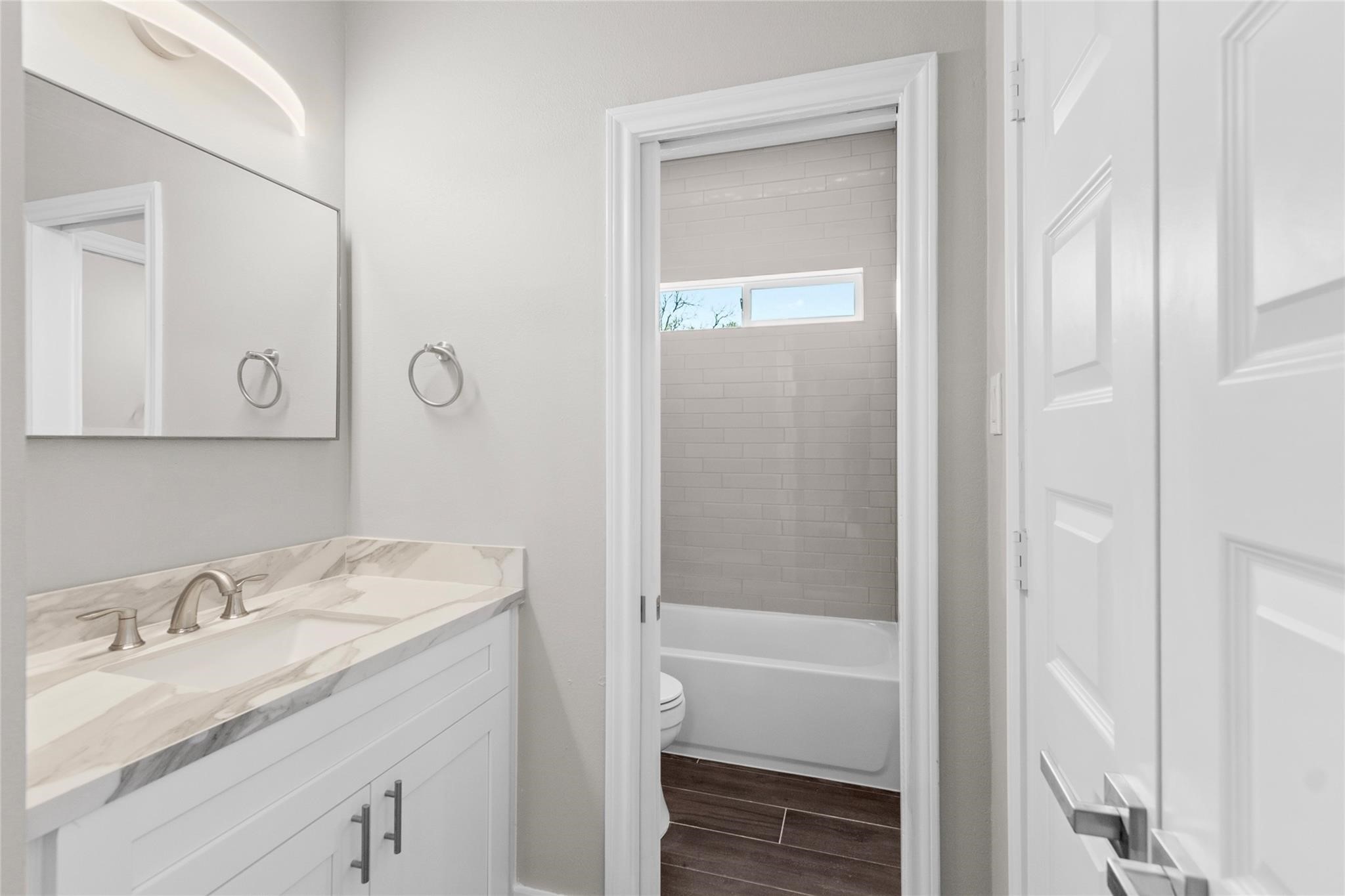 5506 Pershing Street Houston, TX 77033 - Photo 22 of 29 a bathroom with a granite countertop sink vanity mirror and shower