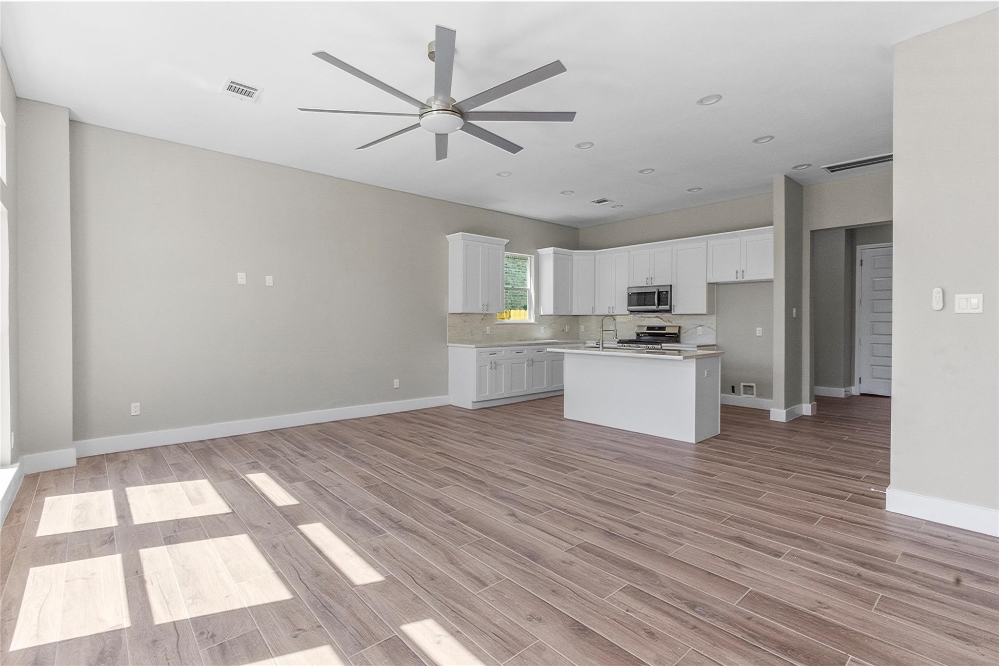 5506 Pershing Street Houston, TX 77033 - Photo 5 of 29 a view of kitchen with wooden floor electronic appliances and window