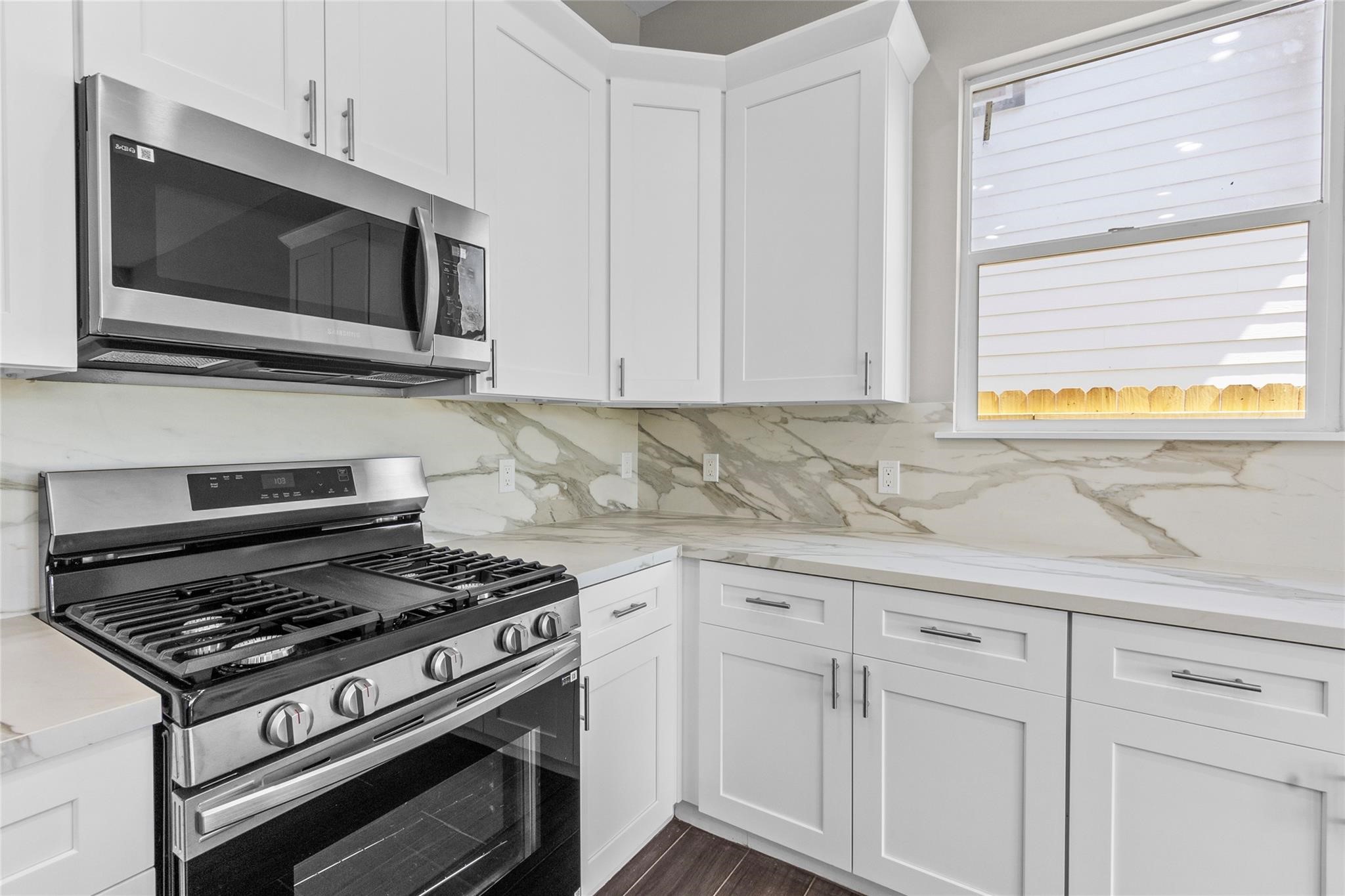 5506 Pershing Street Houston, TX 77033 - Photo 8 of 29 a kitchen with a stove and a microwave