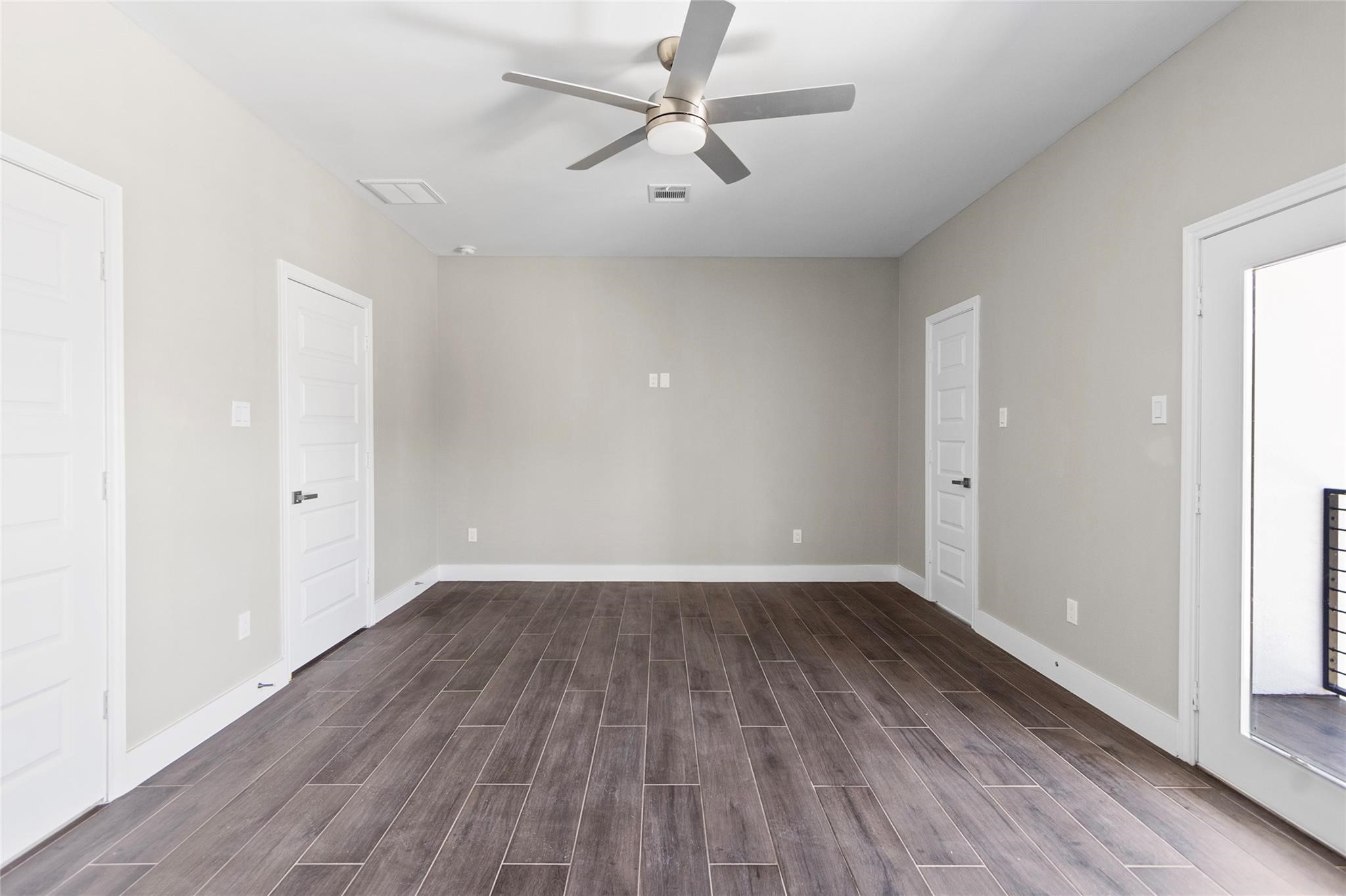 5506 Pershing Street Houston, TX 77033 - Photo 10 of 29 an empty room with wooden floor ceiling fan and windows
