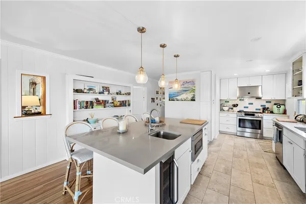 a kitchen with granite countertop kitchen island stainless steel appliances a table and chairs