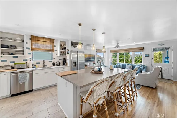a kitchen with stainless steel appliances granite countertop a stove and white cabinets