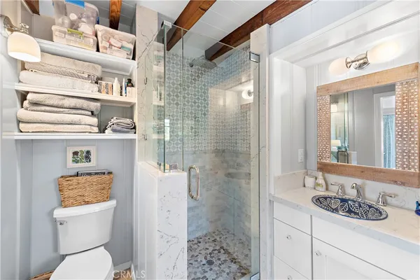 a bathroom with a sink a toilet and shower