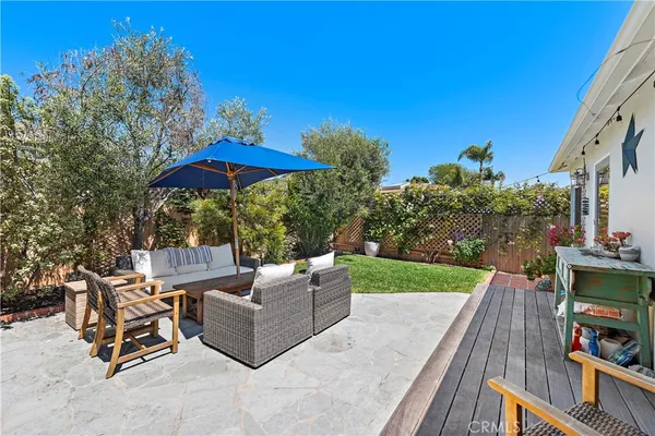 a view of backyard with outdoor seating and trees