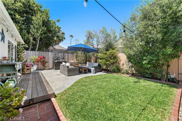 a view of a backyard with sitting area and furniture