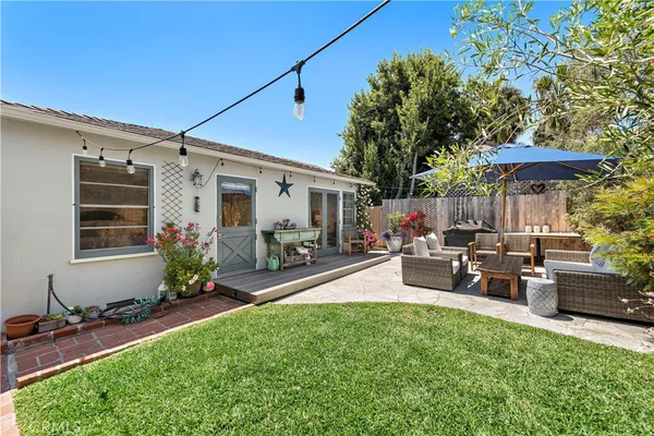a view of a patio with table and chairs under an umbrella