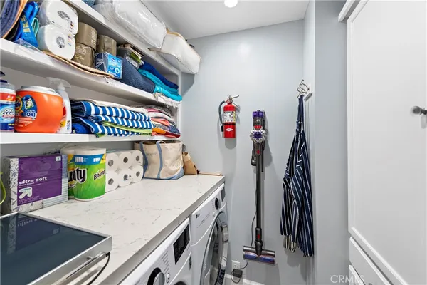 a utility room with dryer and baby