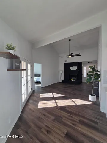 a kitchen with white cabinets and sink