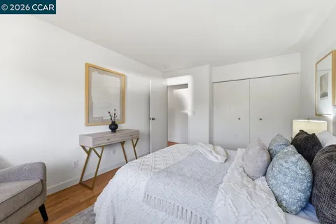 a bedroom with a bed and a chair