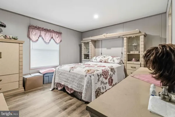 a bedroom with a bed and glass walk in closet